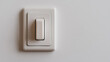 © photo for everything - A simple white electrical switch is mounted on a matching wall, embodying minimalist design and functional technology in a residential or commercial space.