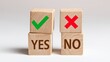 © Sutasinee - A wooden cube, green check mark cube and red cross mark cube on white background, Yes and No, concept decide to choose a vote. Yes or No decisions indicating confirmation or correctness.