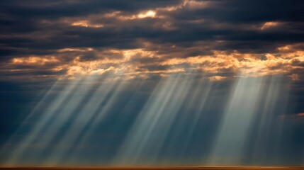 Wall Mural - Dramatic Sunlight Rays Break Through Dark Clouds Over Tranquil Ocean Landscape at Sunset, Illuminating the Water with Soft Golden Hues