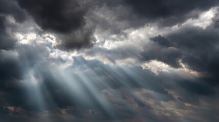 Wall Mural - Dramatic Clouds in a Sky with Sunlight Rays Breaking Through Dark Stormy Atmosphere Creating a Stunning Natural Light Display