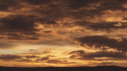 Wall Mural - Dramatic Sunset Over a Serene Landscape with Vibrant Clouds and Golden Hues Casting a Beautiful Reflection on the Horizon in Early Evening