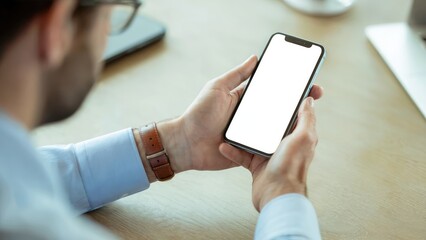 Professional man using a phone with blank screen for your app or website design in a modern office setting