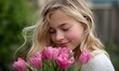 © simba kim - A young girl with blonde hair, highlighted with delicate glitter, is captured in a moment of pure bliss as she brings a vibrant bouquet of pink tulips to her face