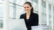 © StocksJust4You - Beautiful young woman smiling confidently while working on laptop in modern bright office, nearest with a stack document and glasses