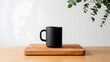 © Dekap - A minimalist black mug on a wooden board with eucalyptus leaves in the background creating a serene scene