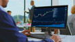© Videophilia - Business professional monitoring financial data on a computer screen, analyzing stock charts and graphs in a modern office environment focused on investment and trade