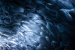 © Erika Valkovicova - Blue frozen abstract ice bubbles in an ice cave in Iceland