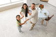 © Pixel-Shot - Happy family dancing in kitchen, top view