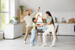© Pixel-Shot - Happy family dancing in kitchen