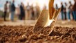 © backup_studio - Golden shovel breaking ground at a ceremony. Men start construction site project. Groundbreaking event for new build.