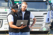 © Serhii - Truck drivers using laptop managing logistics operations