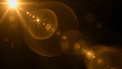 Wall Mural - Golden Sunbeam Lens Flare Effect - A bright golden sunbeam creates a stunning lens flare effect against a dark background.