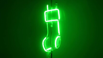 Wall Mural - Neon Green Glowing Light - A bright neon green light illuminates in the center of the frame. The background is a solid green color.