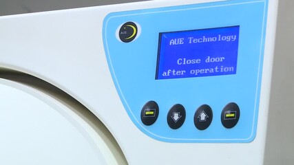 Operator precisely works modern CNC control panel, pressing buttons and adjusting settings. Close-up shot in an advanced manufacturing environment.