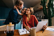 © (JLco) Julia Amaral - Brief family bonding moment as mom works on laptop at kitchen table
