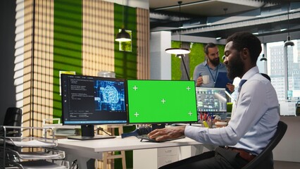Engineer writing code on green screen PC, developing machine learning APIs. IT expert using mockup PC to troubleshoot software errors using artificial intelligence, camera A