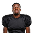 © velikiyzayats - Serious young African American football player in black jersey, studio shot against a dark background.