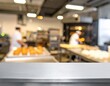 © PutriNurAlleya - Empty stainless steel countertop in blurred professional bakery kitchen