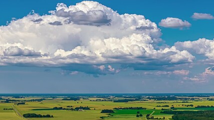 Wall Mural - Large cumulonimbus cloud forming over a large green plain