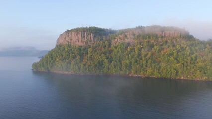 Wall Mural - Fog rolls across the wild Ontario coast of Lake Superior, shrouding steep cliffs and golden autumn trees in a quiet, ethereal light.