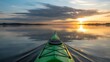© Raza - Kayaking on calm lake during beautiful sunset adventure
