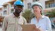 © Z A C - Man and woman in hard hats at construction site.