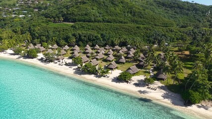 Wall Mural - Drone Shot of Moorea, French Polynesia. Beachfront Villas, Turquoise Lagoon Water and Green Hills