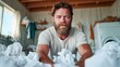 © JoxyAimages - A focused man, dressed casually, is folding laundry in a bright and airy room, showcasing the everyday moments of life and responsibility in a home setting.