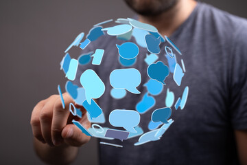 A man interacts with virtual speech bubbles, symbolizing communication, technology and social media. Concept for digital interaction.