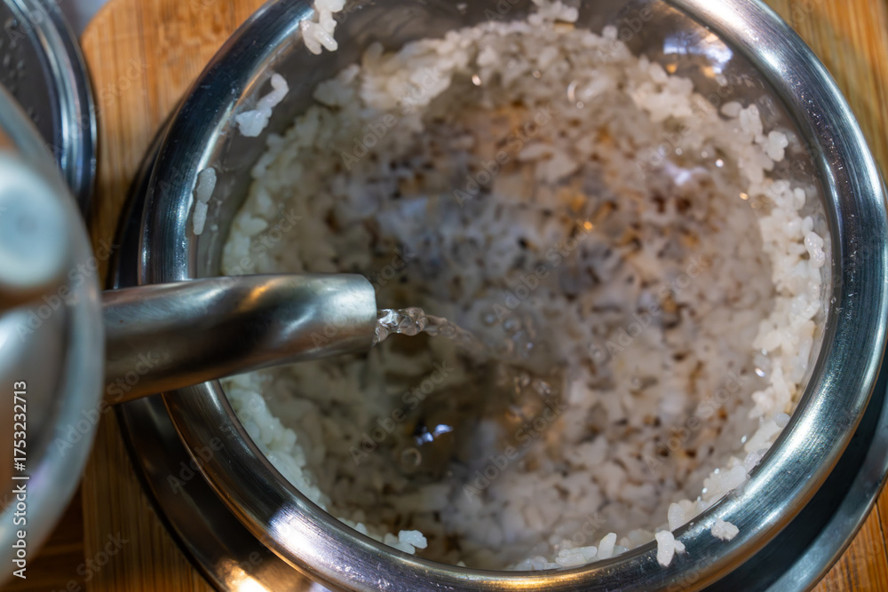 Scorhed Rice Images pouring water into the scorched rice in the pot Stock Photo | Adobe Stock