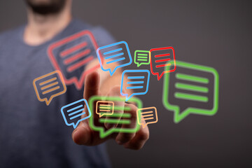 Conceptual image of a man interacting with vibrant speech bubbles symbolizing modern communication and online conversation.