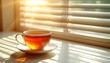 © NurNazira - A cup of tea sits bathed in warm morning sunlight
