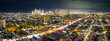 © Austockphoto - Aerial night time panorama of colourful lights of high rise buildings of a city skyline in Melbourne