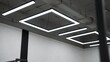 © Ruslan - Contemporary office space displaying concrete ceiling and minimalist square led light fixtures, creating a modern, industrial aesthetic