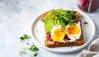 © Hhtps - Colorful, layered toast with avocado, egg, and sprouts, on a plate