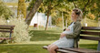 © RecCameraStock - Happy pregnant woman sitting outside touching her belly calming the baby. Future mother having a break in nature.