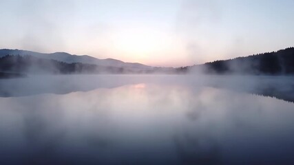 Wall Mural - gentle mist slowly rolling over a tranquil lake surface at dawn beautiful, quiet, water