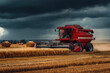© Volha - Red agricultural harvester working in golden wheat field under dramatic stormy sky, showcasing modern farming technology and the beauty of rural landscapes during harvest season