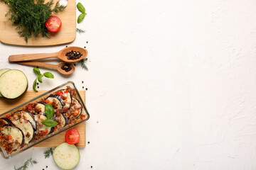 Wall Mural - Baking dish with eggplant slices, ground meat, vegetables and cheese on light background