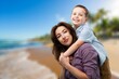 © BillionPhotos.com - Smiling mother and son having fun together at the beach.