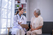 © Wasana - Doctor discussing health with elderly patient during home visit