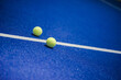 © Yusta Mizan - Sport concept with padel ball on blue surface