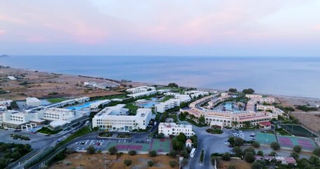 Wall Mural - Drone rising around hotel complexes, dusk on the coastline of Rhodes, Greece