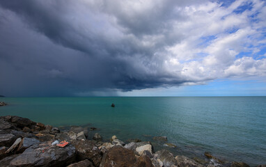 Wall Mural - Stormy sky with a boat in the water