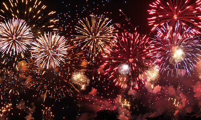 Colorful fireworks exploding in the night sky, celebrating a festive event with bright lights and sparkling effects.