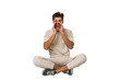 © Asier - Young caucasian man sitting on the floor isolated on white background shouting excited to front.