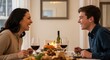 © yevhen89 - Mature woman and young man laughing at dining table with food and wine glasses during autumn holiday dinner at home
