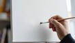 © Marcelino Victor M - Hand painting first brush stroke on blank canvas — creative art process in bright studio