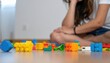 © Marcelino Victor M - Colorful building blocks scattered on floor — playtime mess and tidy up parenting moment