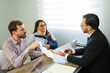 © AntonioDiaz - Clients discussing accident claim with lawyer in office
